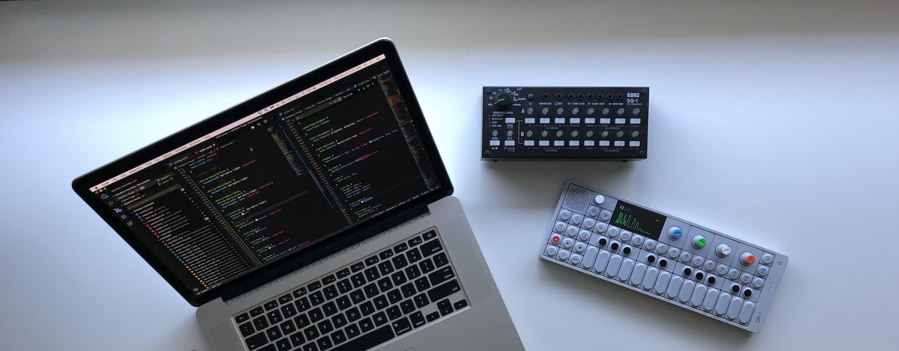 Image of a synthesizer with a laptop and sequencer.